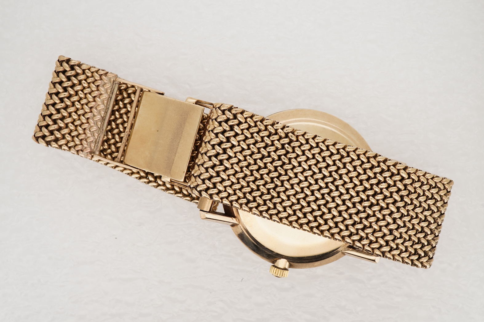 A gentleman's early 1970's 9ct gold Omega De Ville manual wind wrist watch, on an associated 9ct gold mesh link bracelet